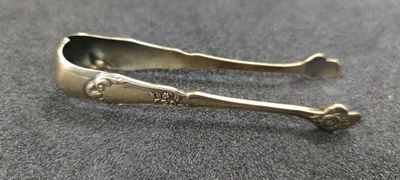 pair of antique silverware spoons on a gray surface