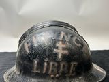 an old fireman ' s helmet on a black table