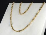 a close up of a gold chain on a marble surface