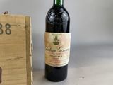 a bottle of wine sitting next to a wooden box