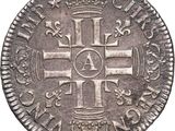 an old silver coin with a cross on it