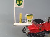 a red toy truck with a gas station sign on it
