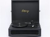 a black record player sitting on top of a white surface