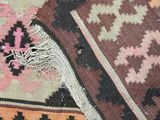 a close up of a colorful rug with fringes on top of it
