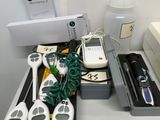 several electronic devices are sitting on a desk in a room