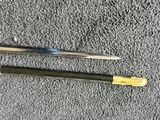 a close up of two swords on a gray surface