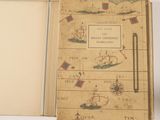 a book with a map inside of it on a table
