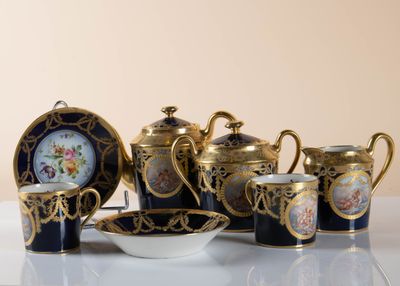 a table with a variety of tea pots and cups
