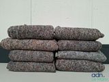 pile of gray and black wool blankets sitting on top of a table