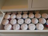 a drawer full of cans of food in a kitchen