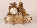 a gold clock sitting on top of a marble table