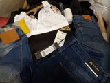 a suitcase full of clothes and a pair of jeans