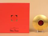 a red box with a gold object in it next to a red box