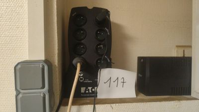 a remote control on the wall next to a box