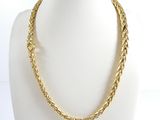 a close up of a gold necklace on a mannequin mannequin