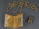 an open book sitting on top of a table next to a chain