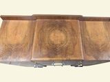 a wooden stove top with a drawer underneath it