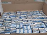 une boîte en carton remplie de liasses de billets, posée sur une table