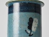 a blue vase with a picture of a surfer on it