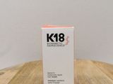 a close up of a bottle of k8 skin care on a wooden table