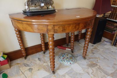 a small wooden table with a clock on top of it