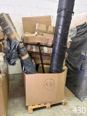 a pile of boxes and other items in a room
