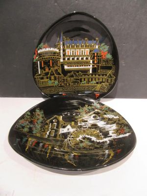 a black plate with a picture of a building on it