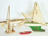 a small boat and a small boat on a white surface