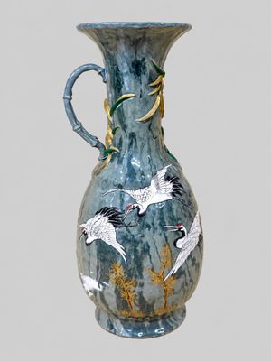 a blue vase with birds painted on the side of it