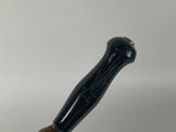 a close up of a black and gold screwdriver on a white surface