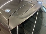a close up of a car ' s rear window with the hood open
