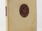 a close up of a book on a table with a white background