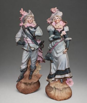 pair of porcelain figurines of two women dressed in period clothing