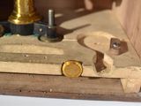 a small wooden box with a clock on top of it