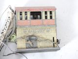 a small model of a train on a white surface