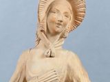 statue of a woman in a dress with a hat on her head