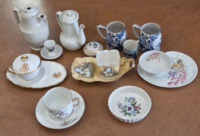 many different types of tea cups and saucers on the table