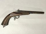 a close up of a gun on a white surface