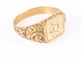 a close up of a gold signet ring on a white background