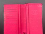 pink leather wallet with a zipper on the inside of it