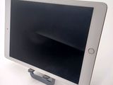 a tablet that is sitting on a stand on a table
