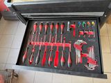 many tools in a tool box on the floor