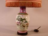 a lamp that is sitting on a table with a lamp shade on it