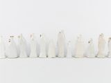 many figurines that are lined up in a row