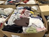 many boxes of clothes that are sitting on the floor