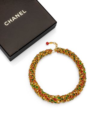 chanel multicolored woven bracelet with red, green, and gold beads