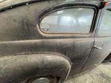 an old car that is sitting in a garage