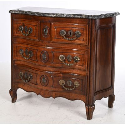 a wooden chest of drawers with marble top on it