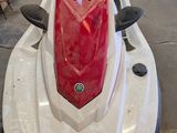 a picture of a white and red jet ski in a garage