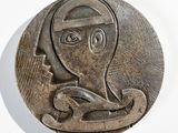 a metal plaque with a picture of a woman on it